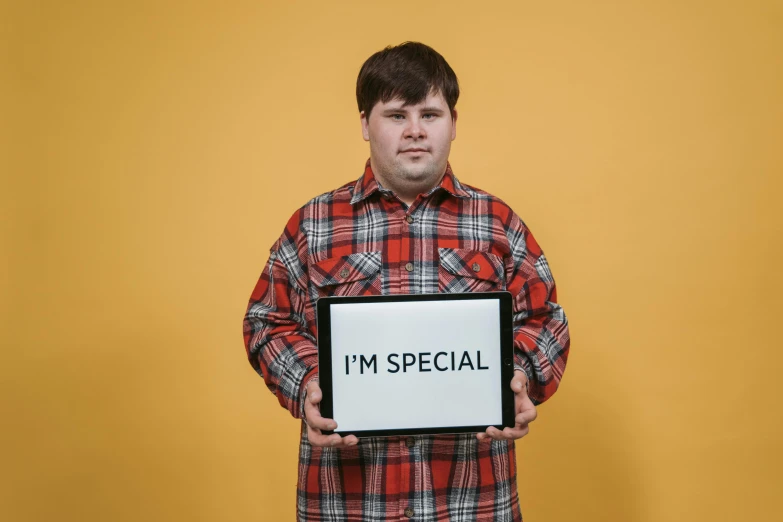 a man holding a sign that says i'm special, an album cover, pexels, realism, jontron, rex orange county, speculative fashion, obese