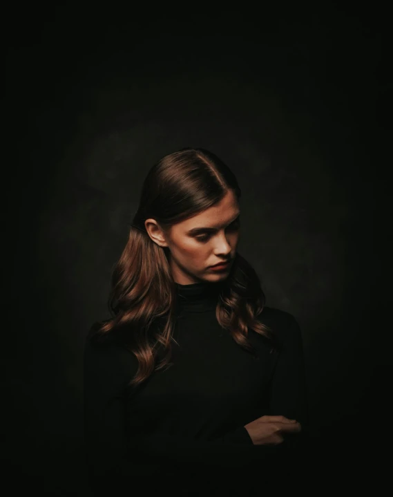 a woman standing in front of a black background, girl with brown hair, looking off into the distance, dark backdrop, promo image