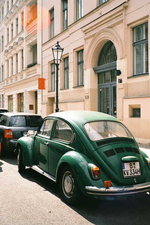 a green vw beetle parked on the side of a street, a photo, pexels contest winner, renaissance, swedish style, 🚿🗝📝, berlin 1 9 8 2, instagram story