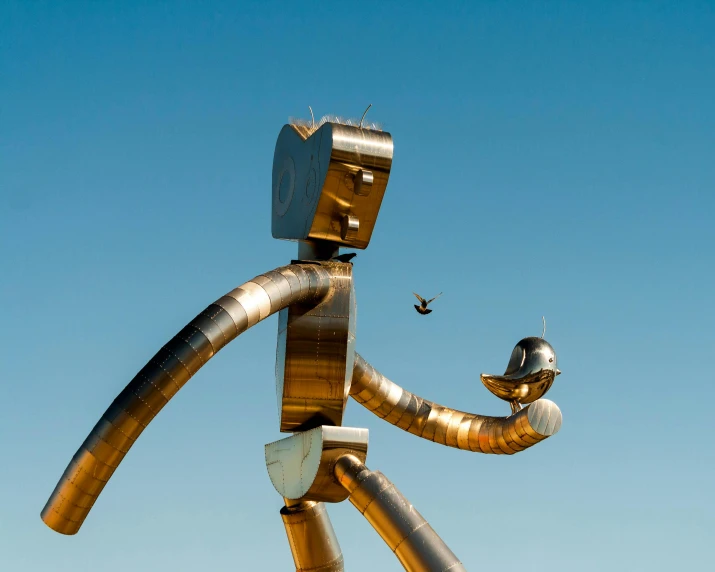 a metal sculpture of a man holding a bird, inspired by Saul Steinberg, pexels contest winner, kinetic art, blue sky, large robot, route 6 6, long arm