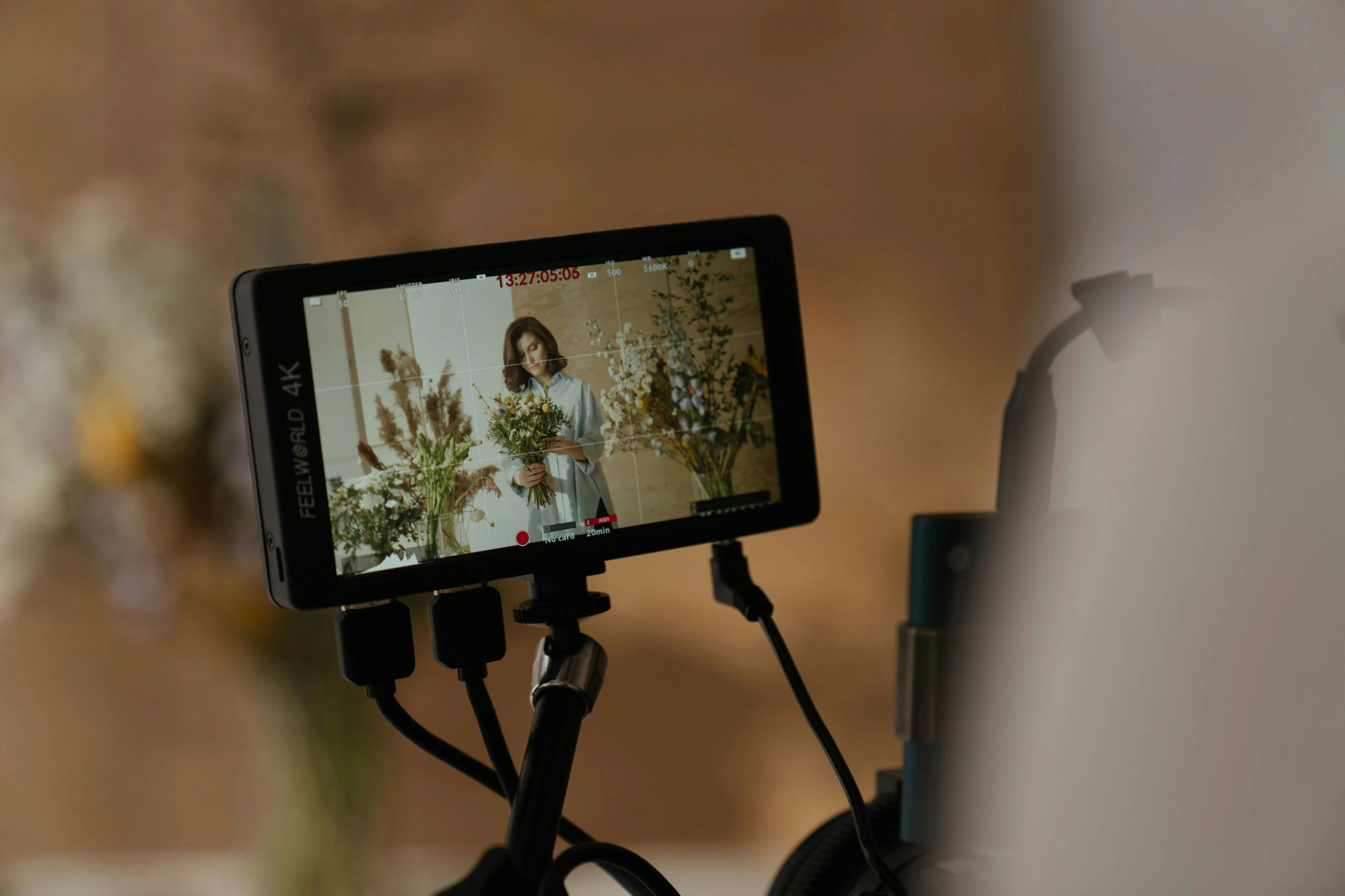 a cell phone sitting on top of a tripod, by Romain brook, trending on pexels, video art, lcd screen, female model, panavision millennium dxl 2, photoshoot for skincare brand