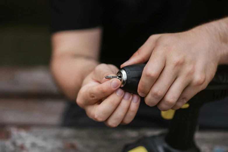 a close up of a person holding a flashlight, screwdriver, matt finish, assembled, 3 2 mm photograph