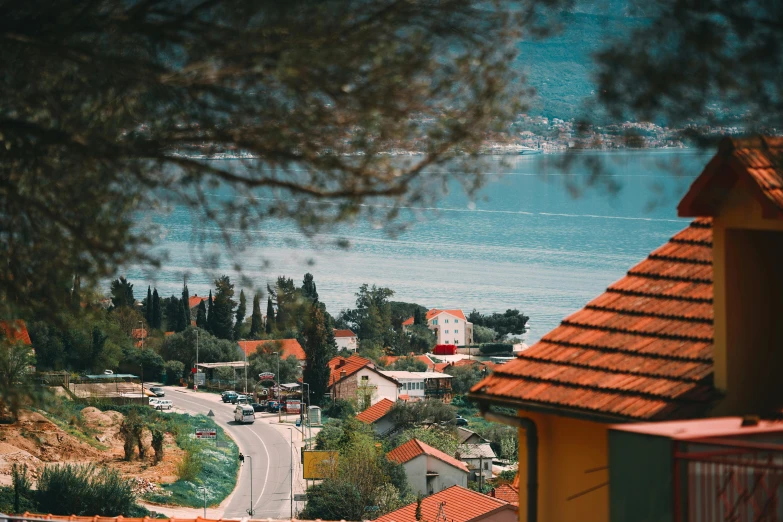 a view of a town from the top of a hill, pexels contest winner, croatian coastline, retro vibe, orange roof, 🦩🪐🐞👩🏻🦳