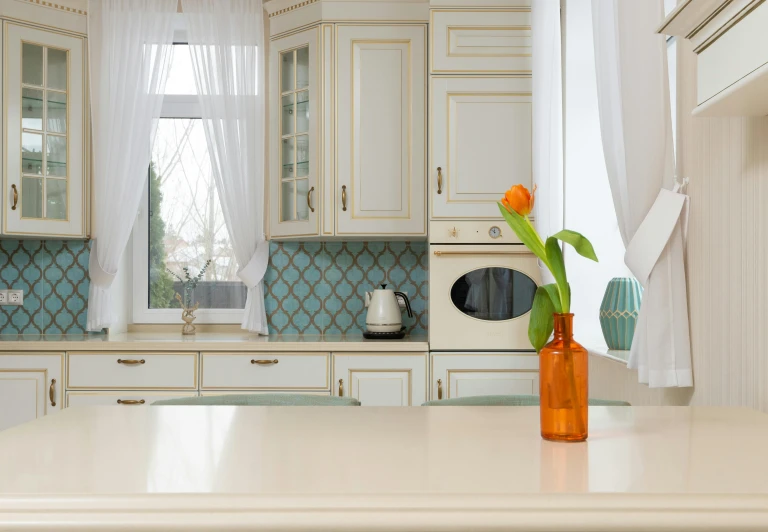 a vase with a flower sitting on a kitchen counter, trending on pixabay, arabesque, aquamarine windows, cream - colored room, white and orange, polish mansion kitchen