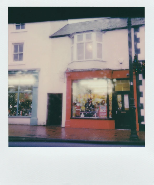 a store front on the corner of a street, a polaroid photo, wales, full of wonders, not blurry, holiday