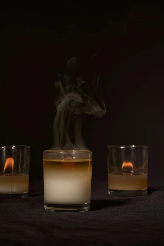 a group of glasses sitting on top of a table, with smoke, product lighting, candle dripping wax, ignant