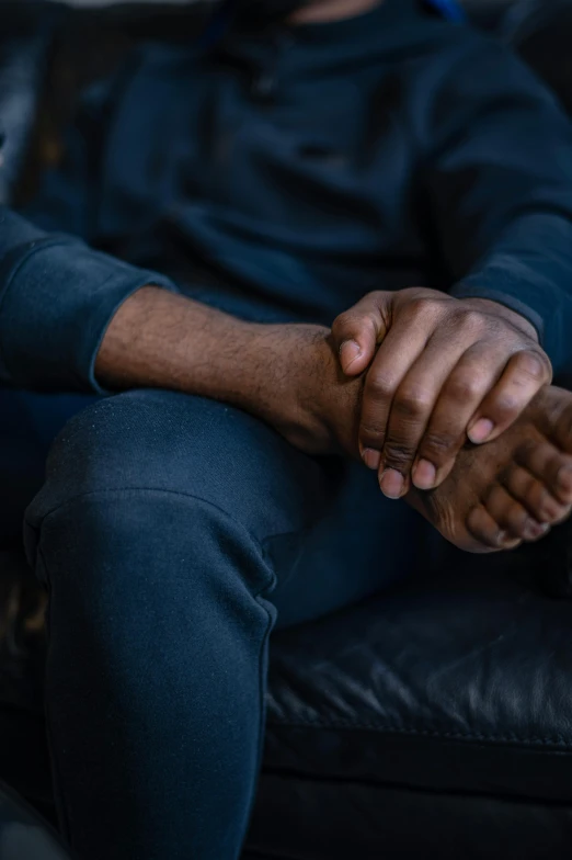 a man and a woman sitting on a couch holding hands, by Andrew Domachowski, trending on unsplash, panel of black, two men hugging, hands crossed, paul barson