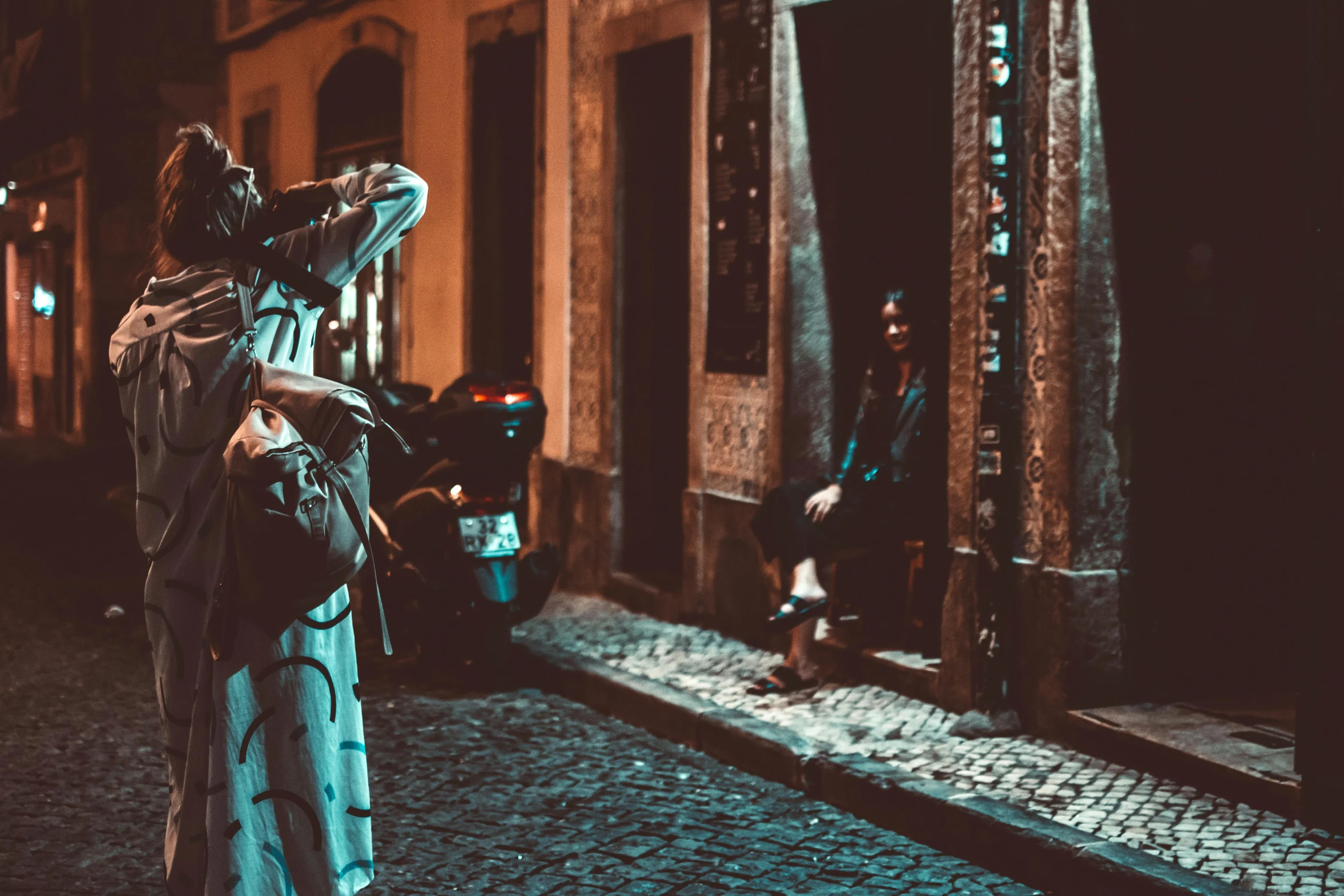 a woman standing on a cobblestone street at night, a statue, by Gina Pellón, pexels contest winner, graffiti, brazilian, papa emeritus, “house music rave with dancers, photo for a magazine