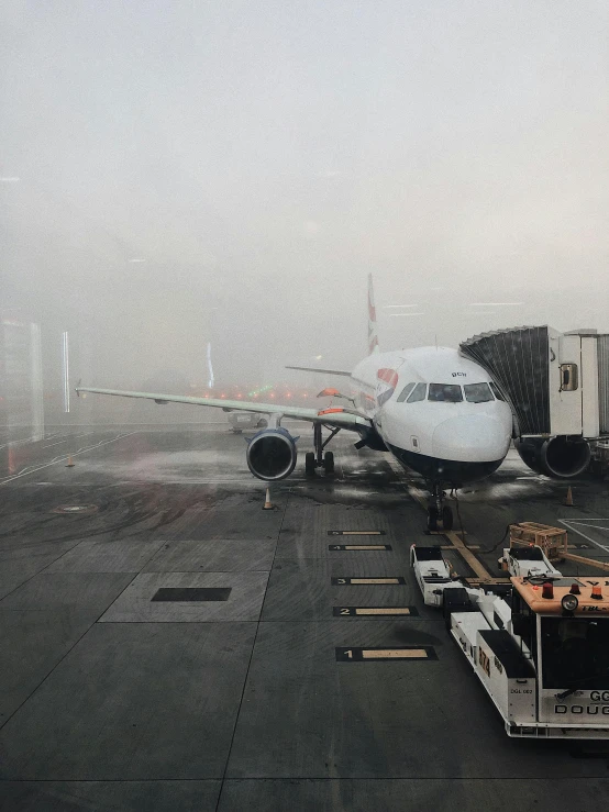 a large jetliner sitting on top of an airport tarmac, an album cover, by Carey Morris, pexels contest winner, foggy rainy day, instagram story, in london, view from inside