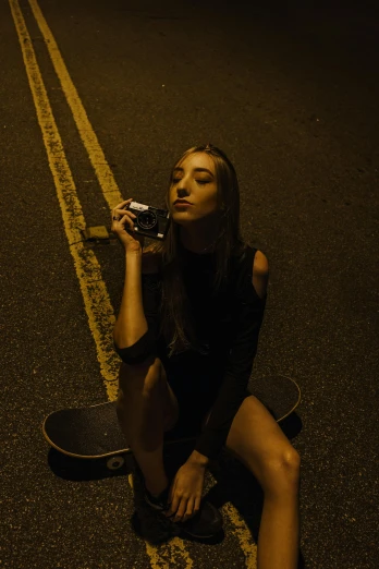 a woman sitting on the side of the road smoking a cigarette, inspired by Nan Goldin, unsplash contest winner, standing on a skateboard, portrait sophie mudd, shot with a gopro, night photo