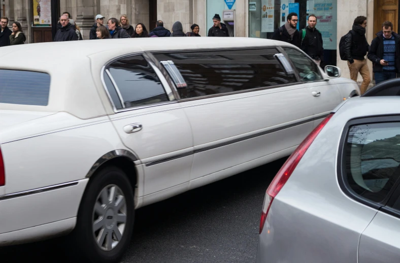 a white limousine parked on the side of a street, pexels, happening, square, a group of people, funeral, up close picture