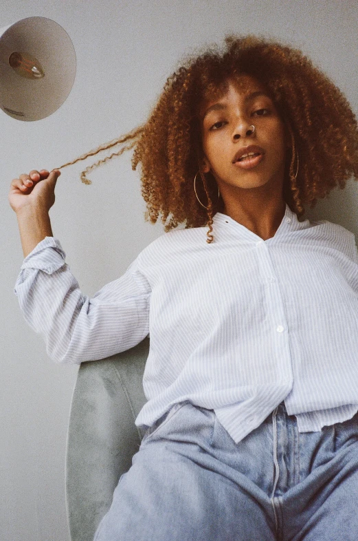 a beautiful young woman sitting on top of a toilet, inspired by Theo Constanté, trending on unsplash, wearing a linen shirt, ashteroth, wearing stripe shirt, press shot