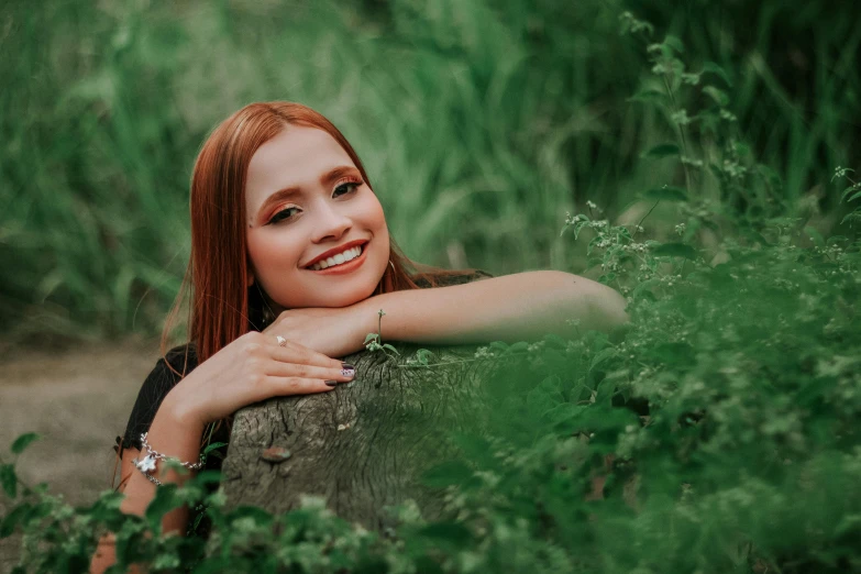 a beautiful young woman sitting on top of a tree stump, pexels contest winner, with red hair and green eyes, perfect smile, avatar image, background image