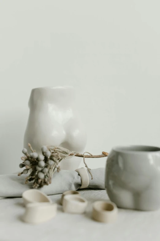a couple of cups sitting on top of a table, a marble sculpture, inspired by Kim Tschang Yeul, trending on unsplash, soft colors mono chromatic, gnarly details soft light, linen, holiday