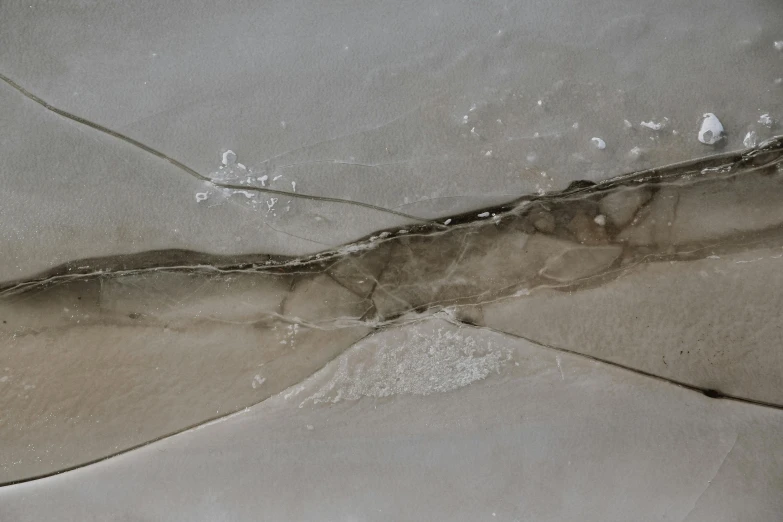 a piece of ice sitting on top of a table, an ultrafine detailed painting, inspired by Lucio Fontana, unsplash, concrete art, sand banks, subsurface cracks, ceiling, grisaille