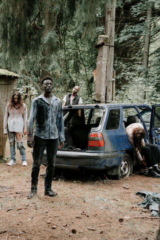 a group of people standing around a car, zombie with white eyes, stood in a forest, seattle, papa legba