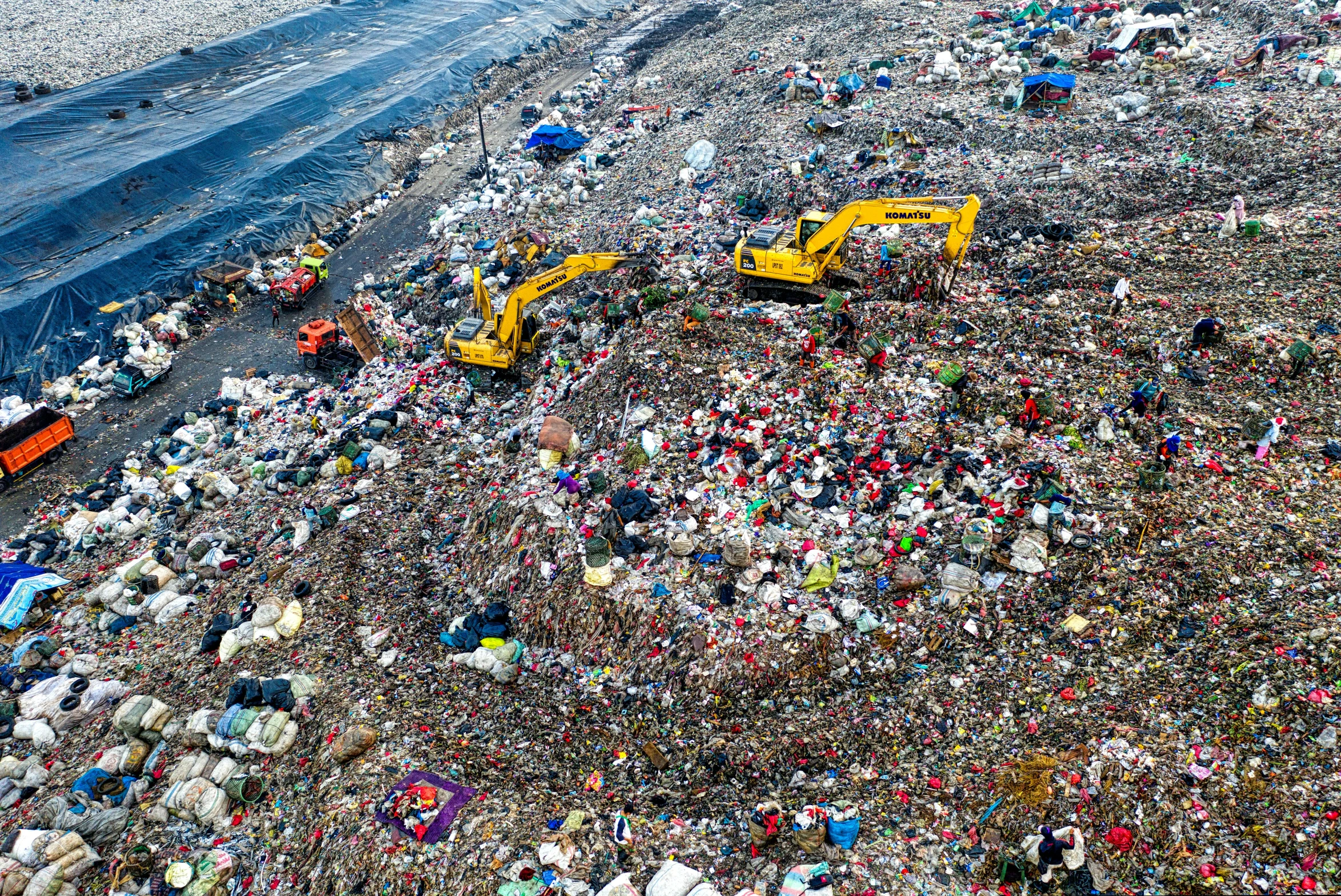 a large pile of garbage sitting on top of a beach, by Adam Marczyński, reddit, plasticien, drone photo, ( ( ( ( ( garbage truck, concert, 💋 💄 👠 👗