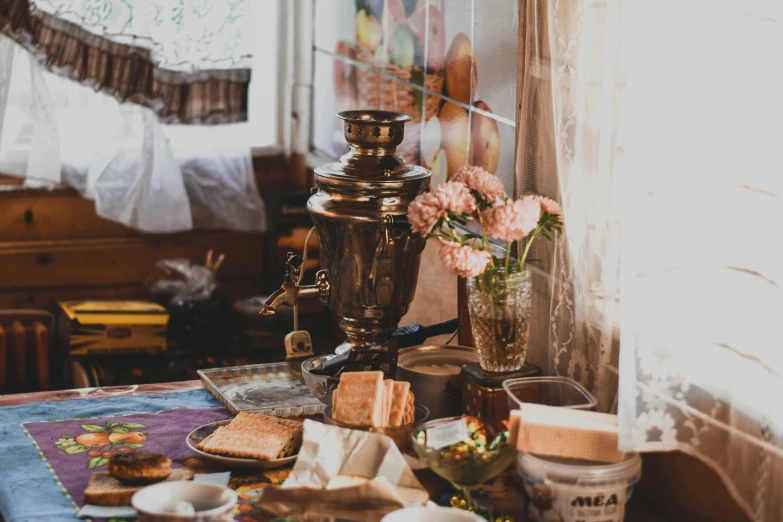 a table topped with lots of food next to a window, by Julia Pishtar, pexels contest winner, arts and crafts movement, ancient coffee machine, ukrainian, brown and pink color scheme, copper and brass