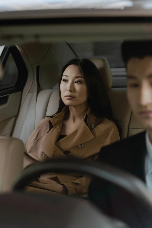 a man and a woman sitting in a car, janice sung, serious business, square, wētā fx