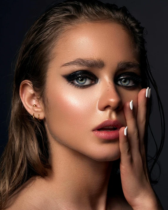 a close up of a woman with a ring on her finger, a colorized photo, inspired by Hedi Xandt, trending on pexels, winged eyeliner, smoky lighting, looking towards camera, detailed product image