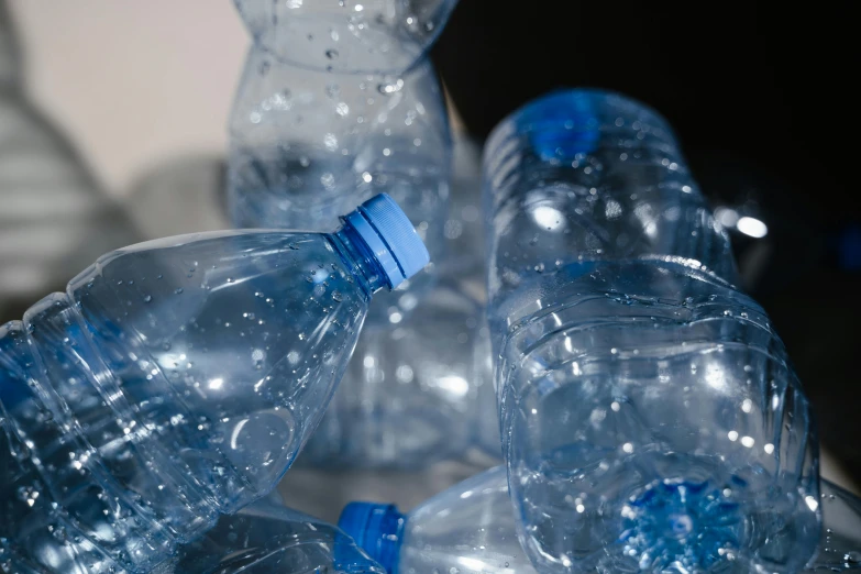 a pile of empty water bottles sitting on top of a table, unsplash, plasticien, avatar image, detail shot, highly realistic”, rivulets