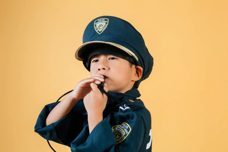 a young boy in a police uniform singing into a microphone, by Alison Geissler, trending on pexels, having a snack, costume, ja mong, profile image