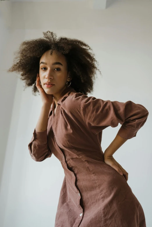 a woman in a brown dress posing for a picture, by Sven Erixson, trending on pexels, ashteroth, brown shirt, soft shapes, dressed in a pink dress