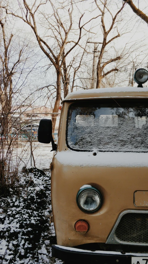 an old truck is parked in the snow, an album cover, by Sven Erixson, trending on unsplash, microbus, low quality photo, muted brown, thumbnail