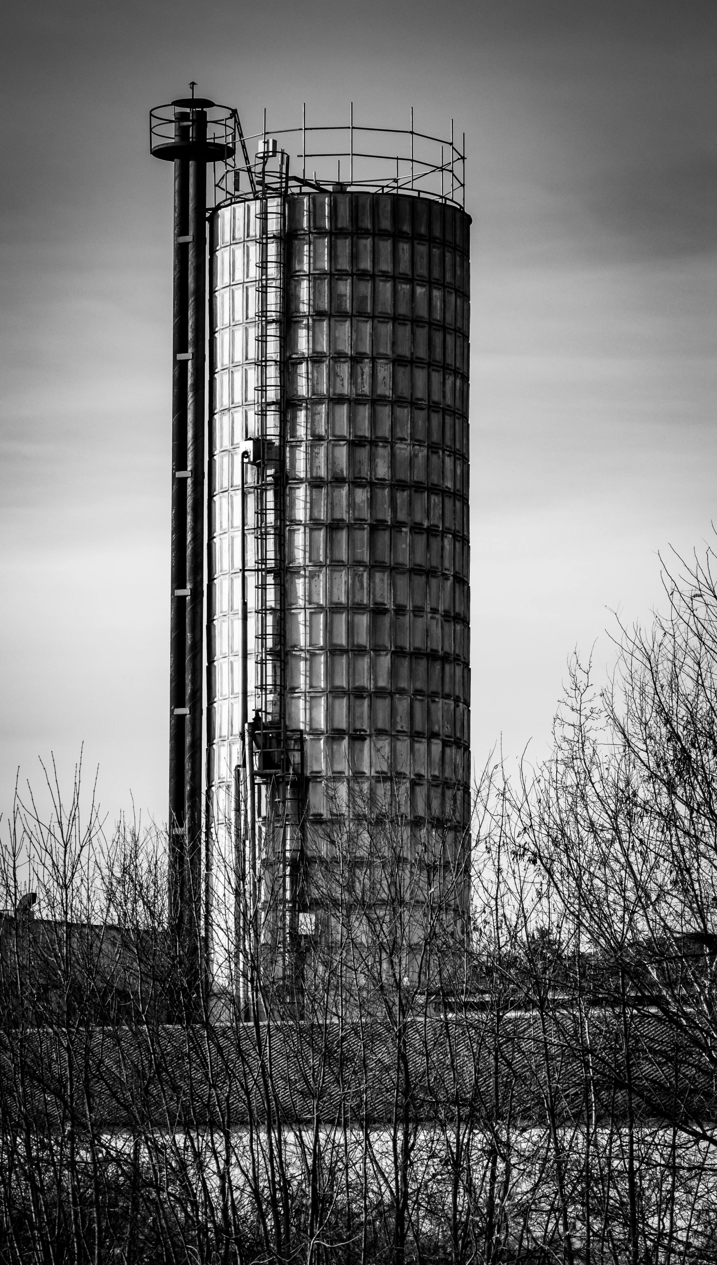 a black and white photo of a tall building, by Sven Erixson, unsplash, brutalism, espoo, glass spaceship, repairing the other one, watertank