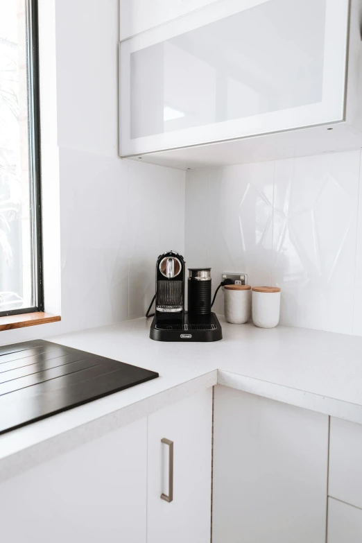 a stove top oven sitting in a kitchen next to a window, by Nicolette Macnamara, unsplash, minimalism, coffee machine, white, angled, aussie baristas