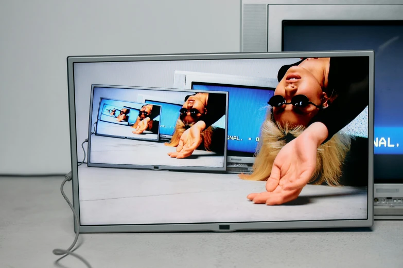 a laptop computer sitting on top of a desk, a hyperrealistic painting, by Marina Abramović, video art, tvs, pc screen image