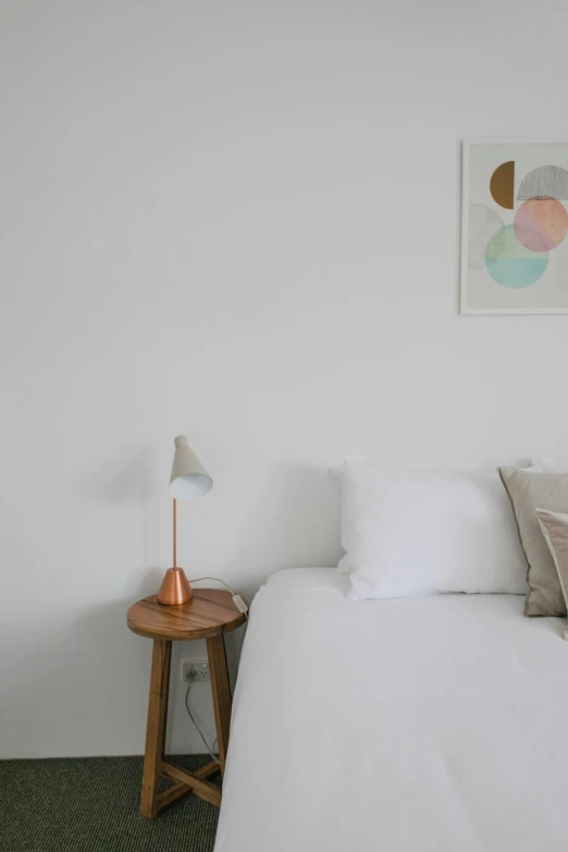 a bed room with a neatly made bed, unsplash contest winner, minimalism, copper details, soft cool colors, lamp, white colors