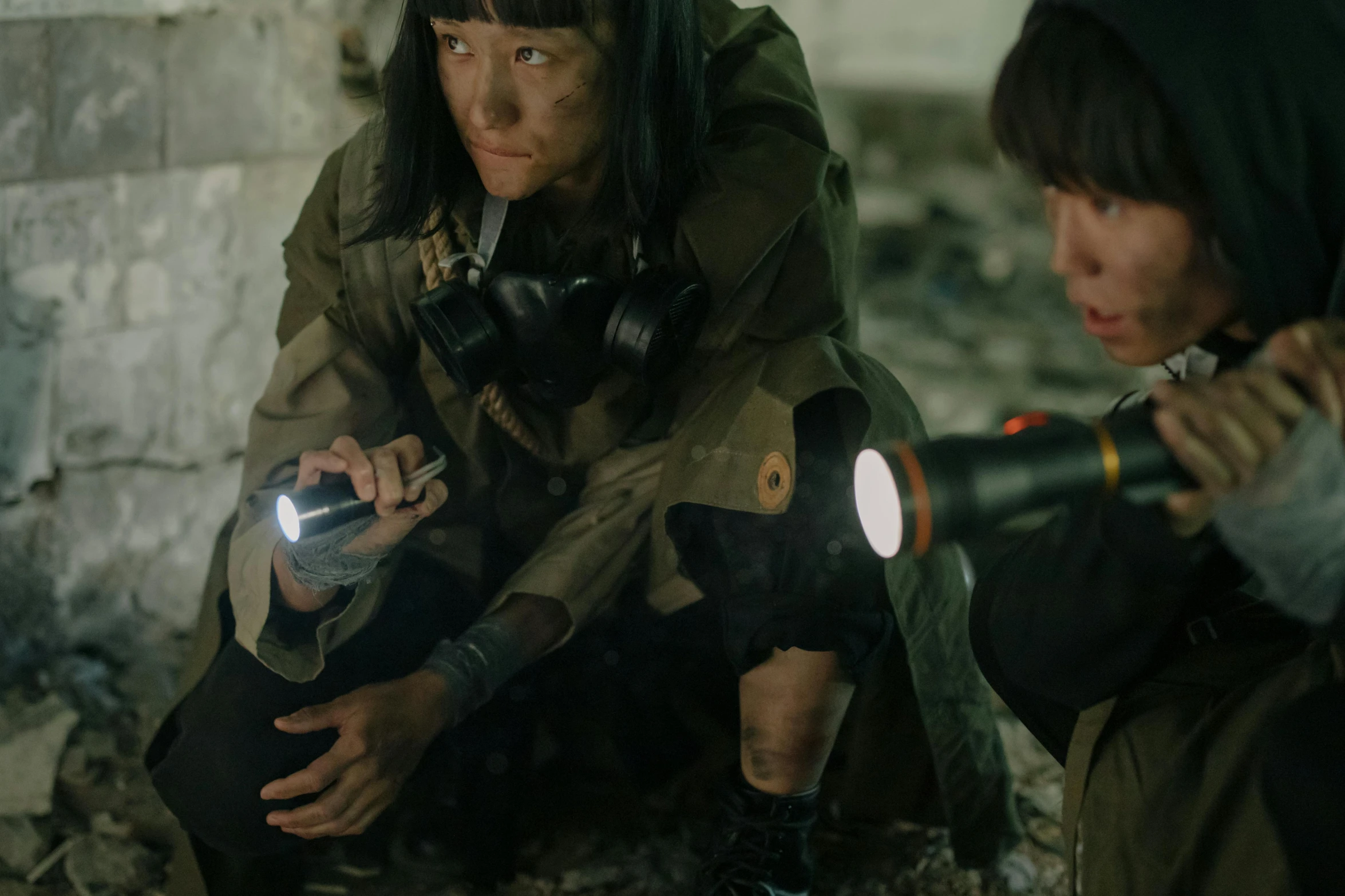 a couple of women sitting next to each other, inspired by roger deakins, pexels contest winner, set in post apocalyptic tokyo, flashlight, getting ready to fight, film still dnd movie