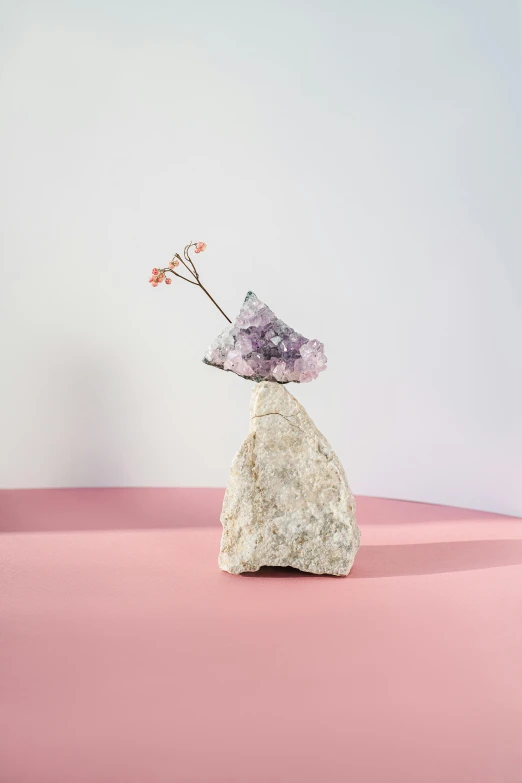 a stone vase sitting on top of a pink surface, by Sam Havadtoy, conceptual art, amethyst mineral quartz, floral growth, prop rocks, minimalist design