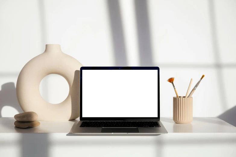 a laptop computer sitting on top of a white desk, by Carey Morris, trending on pexels, computer art, white ceramic shapes, serene lighting, japanese collection product, rectangle