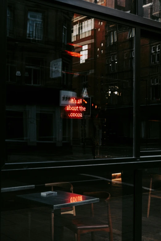 a couple of wooden chairs sitting in front of a window, inspired by Elsa Bleda, unsplash contest winner, red neon lights inside it, dark city bus stop, high reflections, tumblr aesthetic