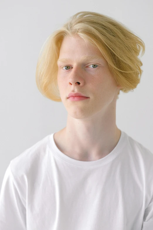 a young man with blonde hair wearing a white t - shirt, by Lasar Segall, featured on reddit, albino hair, studio photo, pouty, toru furuya