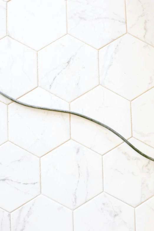 a hair dryer sitting on top of a tiled floor, by Carey Morris, trending on pexels, arabesque, braided cable, made of carrara marble, bezier curve, olive