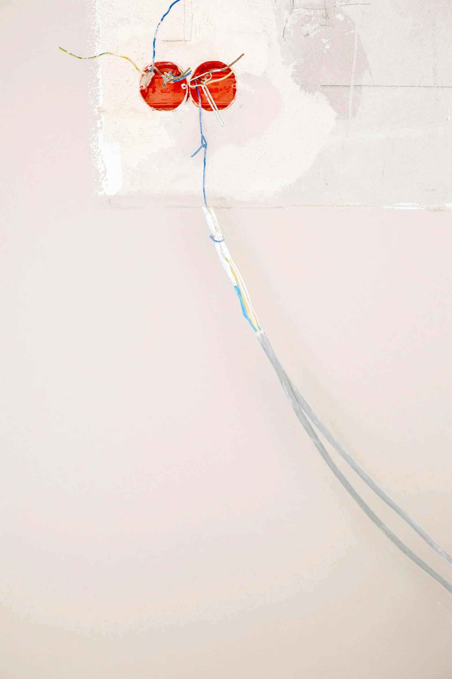 a red and white kite sitting on top of a white wall, by Cerith Wyn Evans, plasticien, detail shot, ethernet cable, pastel glaze, made of wire