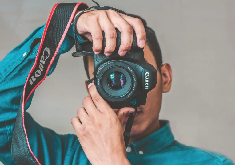 a man taking a picture with a camera, pexels contest winner, headshot profile picture, coloured photo, mana shooting from his hands, canon eos rebel