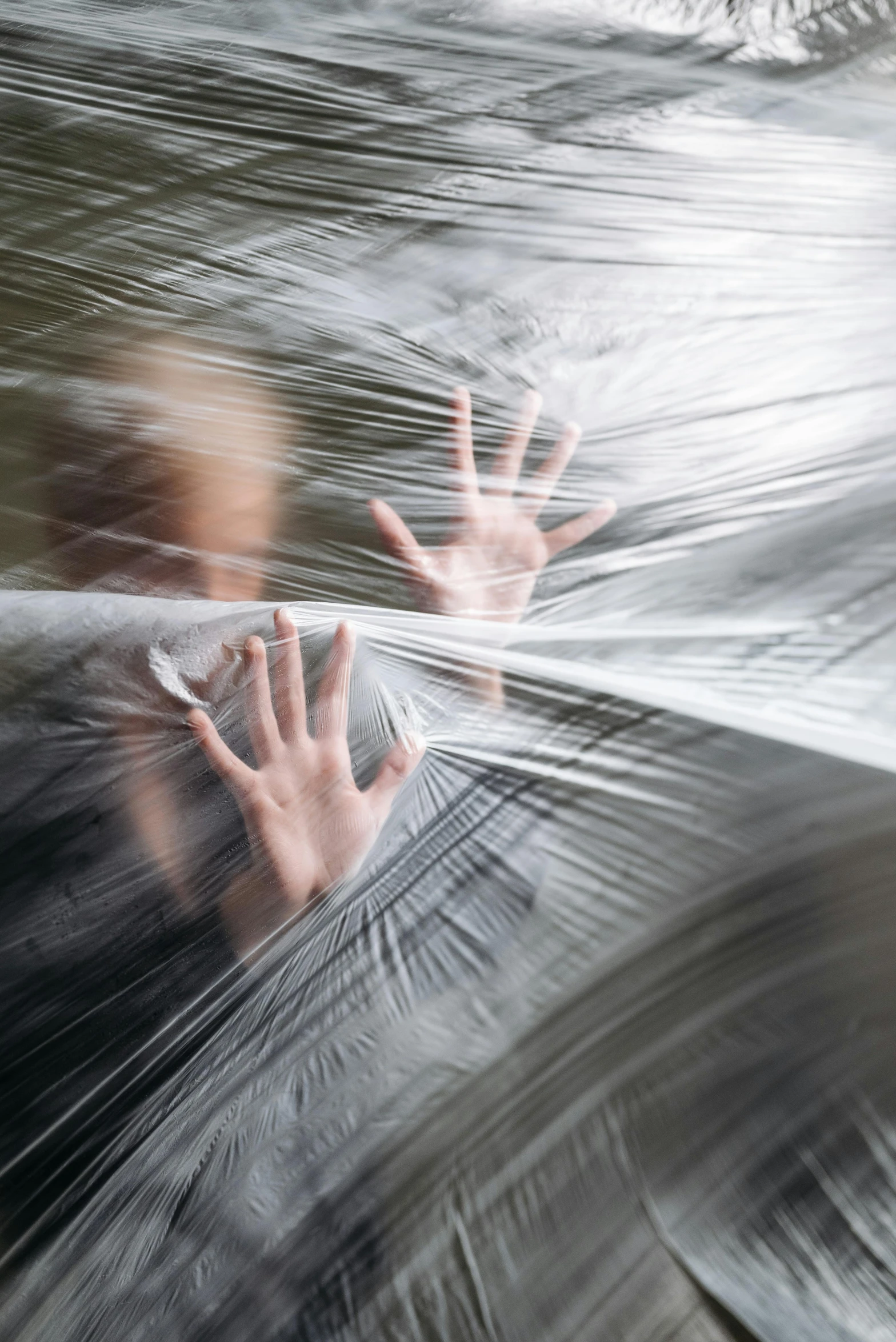 a blurry image of a person wrapped in plastic, shutterstock contest winner, conceptual art, trying to escape, motion lines, frightened, ignant