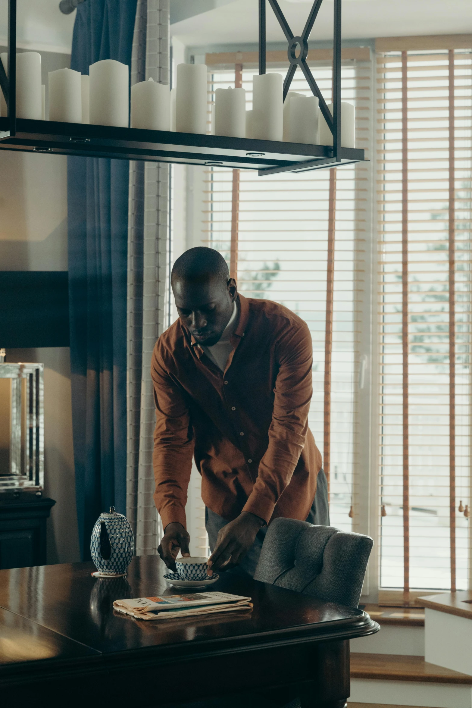 a man standing in front of a laptop computer, by Andries Stock, pexels contest winner, cinematic luts, lance reddick, indoor scene, apartment