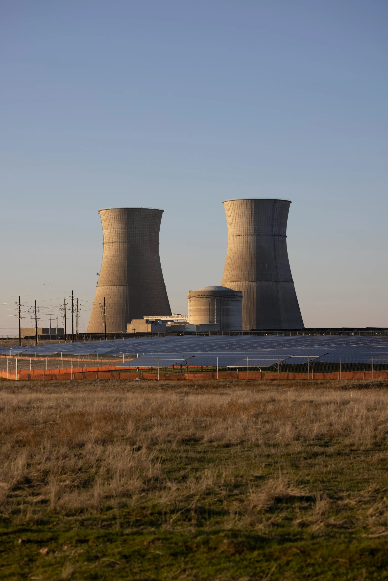 a couple of cooling towers sitting in the middle of a field, by Jeffrey Smith, oklahoma, reactor, 2022 photograph, february)