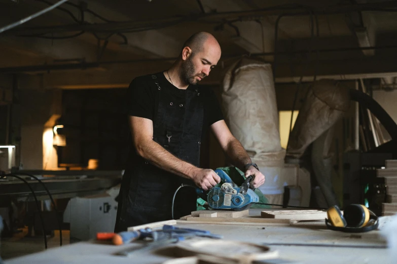 a man using a circular saw to cut a piece of wood, a portrait, pexels contest winner, arts and crafts movement, lachlan bailey, inspect in inventory image, jovana rikalo, thumbnail