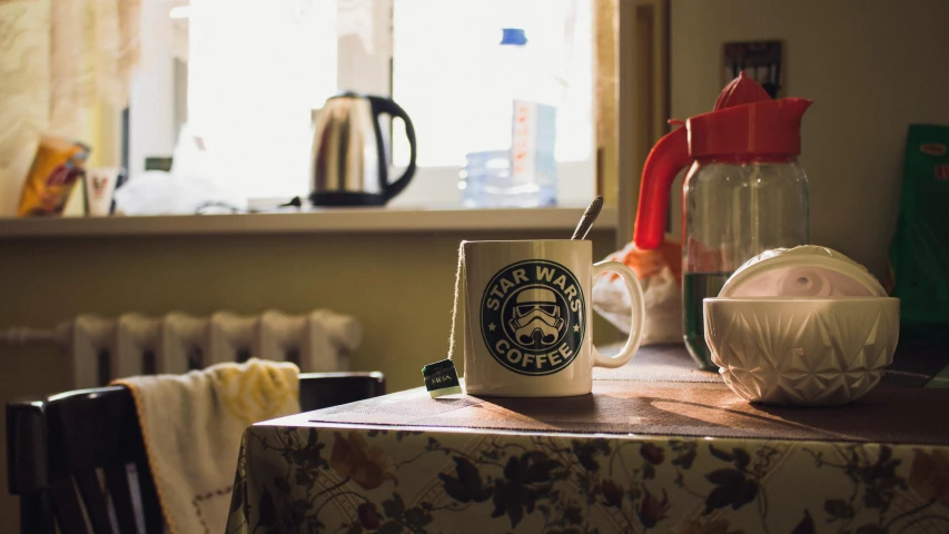 a coffee cup sitting on top of a table, inspired by Elsa Bleda, unsplash, star wars atmosphere, in a kitchen, stormtrooper, historically accurate