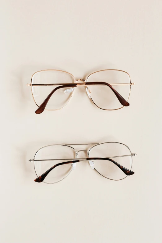 three pairs of glasses on a white surface, gold framed, fan favorite, #trending, medical