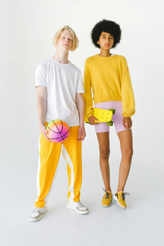 a couple of women standing next to each other, dribble, colors: yellow, off - white collection, basketball, non binary model