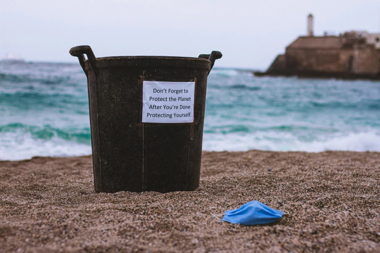 a trash can sitting on top of a sandy beach, pexels contest winner, plasticien, label, cornwall, no planets, cone