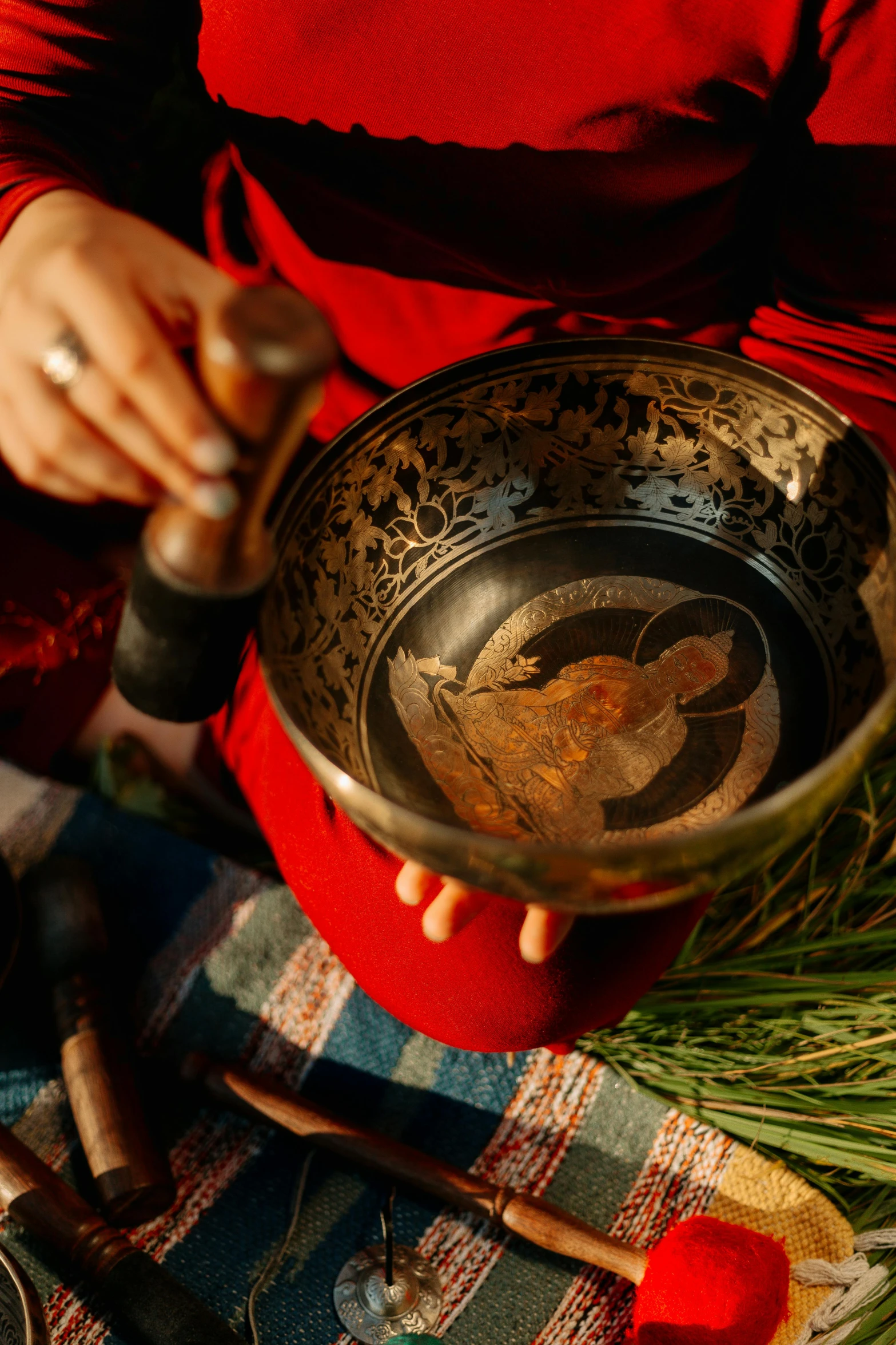 a woman in a red shirt is holding a singing bowl, an album cover, by Matthias Stom, trending on unsplash, cloisonnism, carving, taken at golden hour, black, bowl filled with food