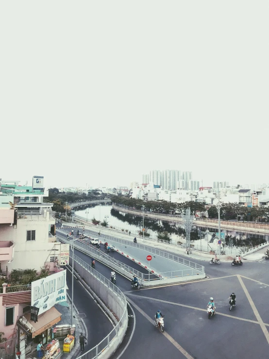 a street filled with lots of traffic next to tall buildings, by Tan Ting-pho, unsplash, scenic view of river, dang my linh, shot on iphone 6, panoramic view